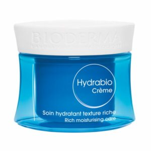 Eau-reiche Hautpflegecreme in einem blauen Glasbehälter mit einem weißen Deckel und beschriftetem Etikett.