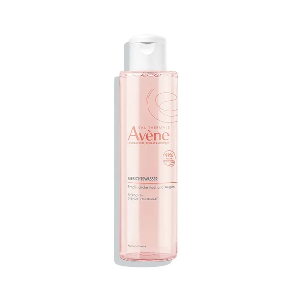 Transparentes Behältnis mit Gesichts-Gel von Avène, geeignet für empfindliche Haut, rosafarbene Flüssigkeit.